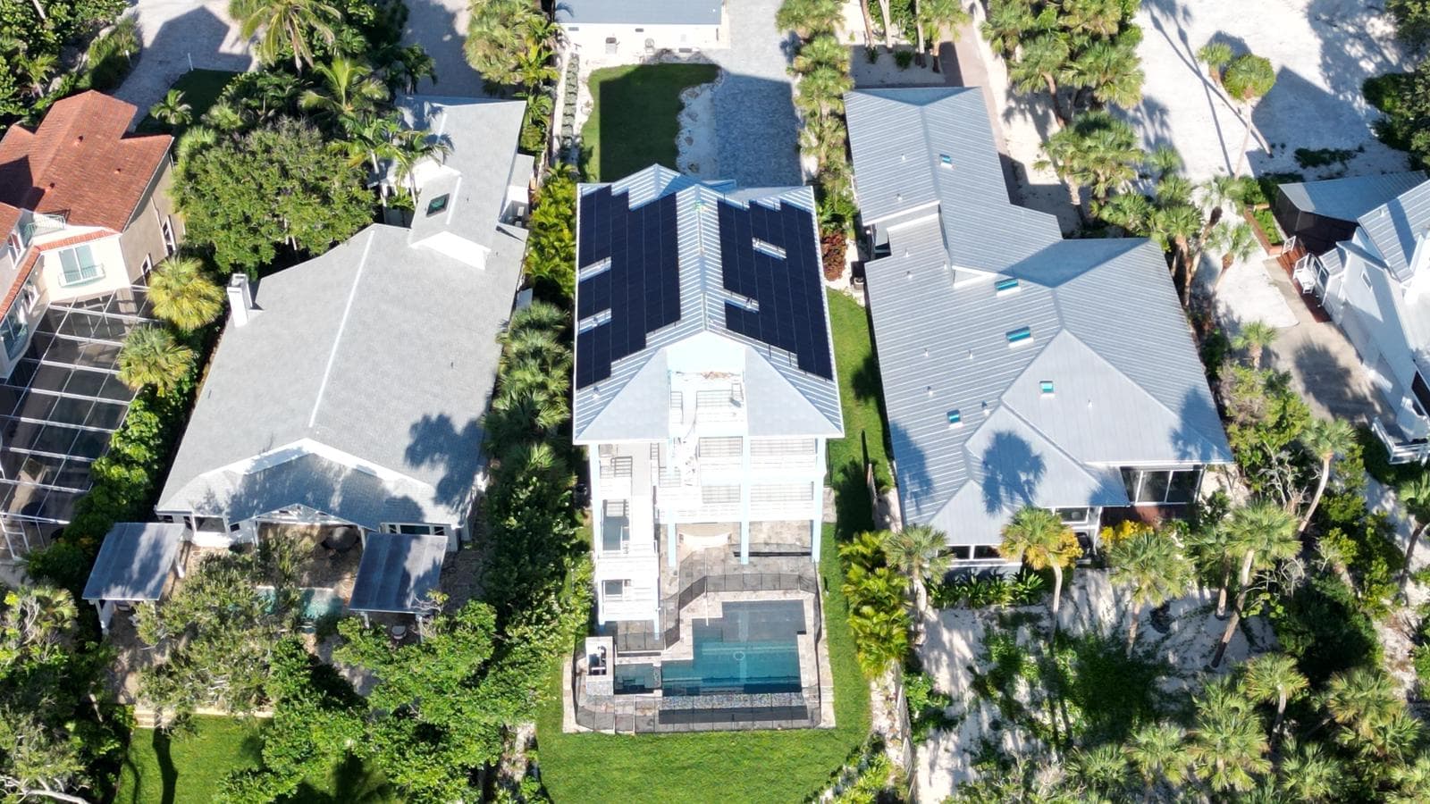 Aerial view of solar installation on two-story coastal home in Southwest FL