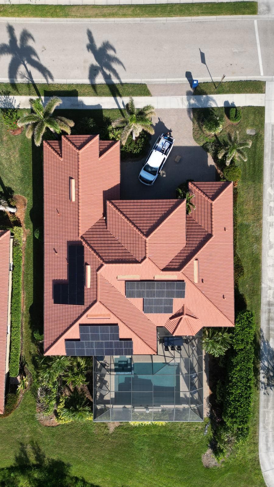 Aerial drone shot of solar panels on terracotta tile roof in Southwest FL