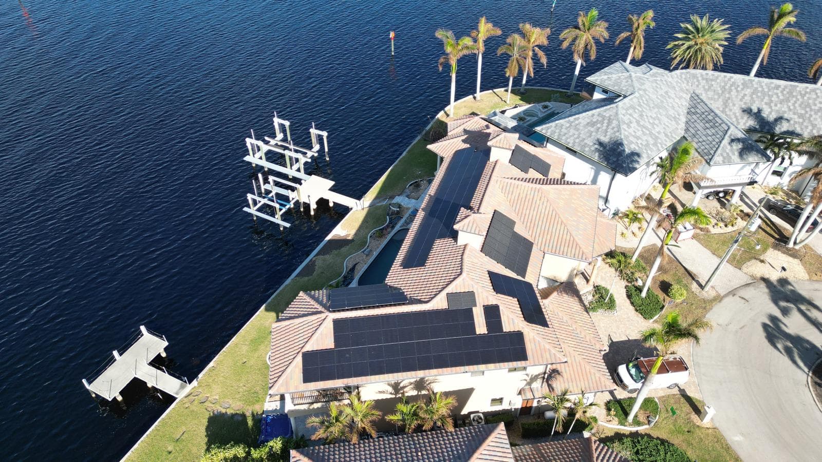 Aerial view of solar panel installation on luxury waterfront home in Southwest FL