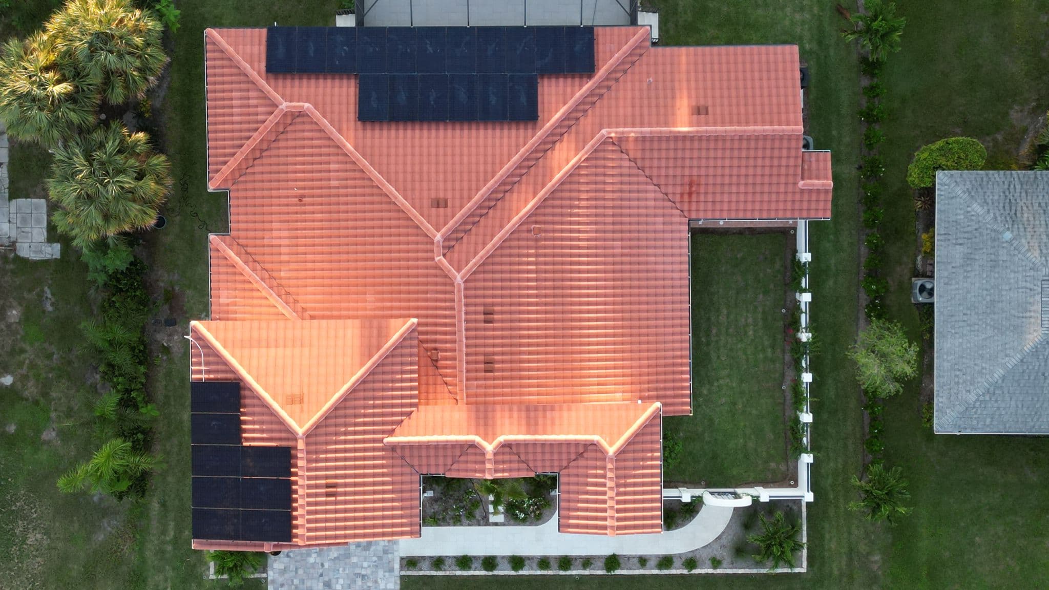 Drone shot of completed solar panel system on tile roof in Venice, FL