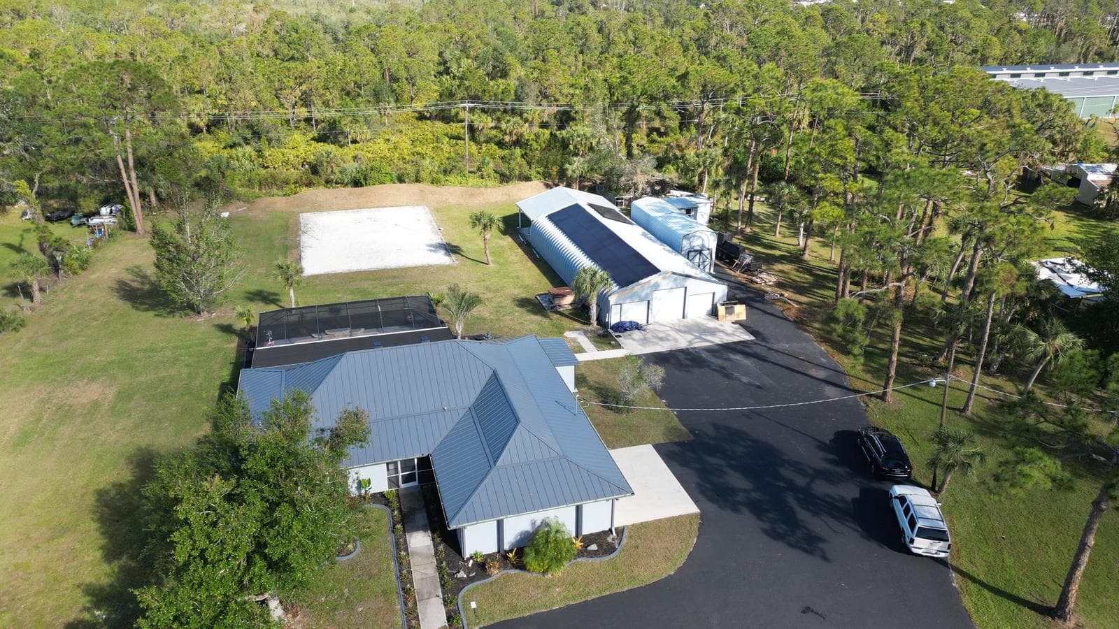Wide aerial overview of commercial solar project on metal building by S7 Solar