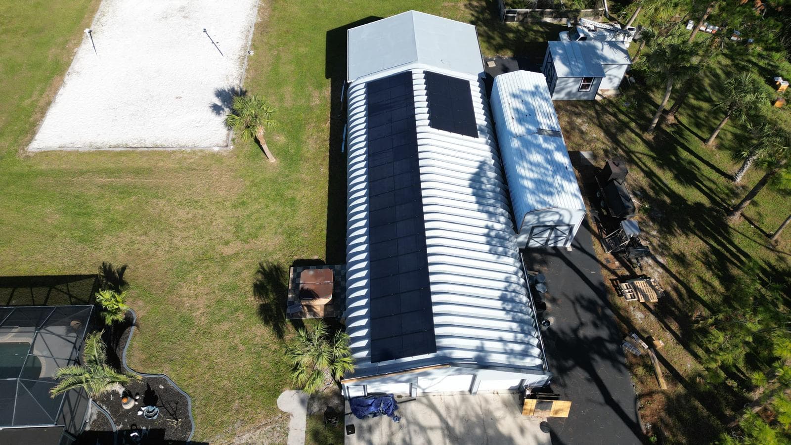 Aerial view of finished solar array on commercial metal structure in Southwest FL